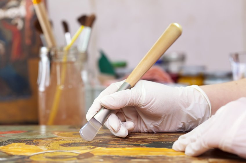 restoration of ancient Christian icon with agate burnishers